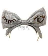 Load image into Gallery viewer, RIBBED BOW HEADBAND WITH FOIL WINK
